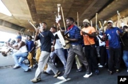 IFP supporters wielding traditional Zulu weapons march through Durban… The NFP accuses the IFP of intimidation ahead of South Africa’s municipal polls on May 18