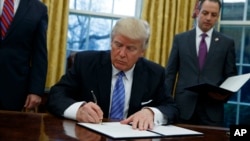 دونالد ترامپ رئیس جمهوری ایالات متحده در حال امضای یک فرمان اجرایی در محل کار خود در کاخ سفید - آرشیو
