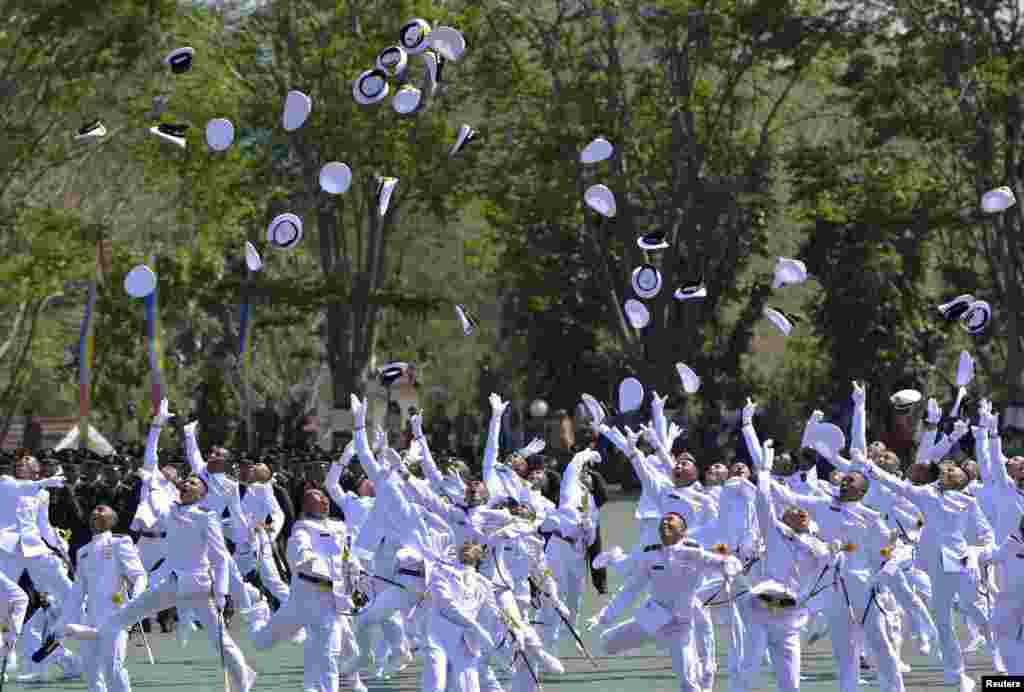 Indonesian Navy cadet graduates celebrate after a ceremony in Semarang, Central Java, in this photo taken by Antara Foto.