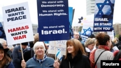 People hold placards during the "Rally for Equal Rights at the United Nations (protesting Anti-Israeli bias)" aside of the Human Rights Council at the United Nations in Geneva, Switzerland, March 18, 2019. 