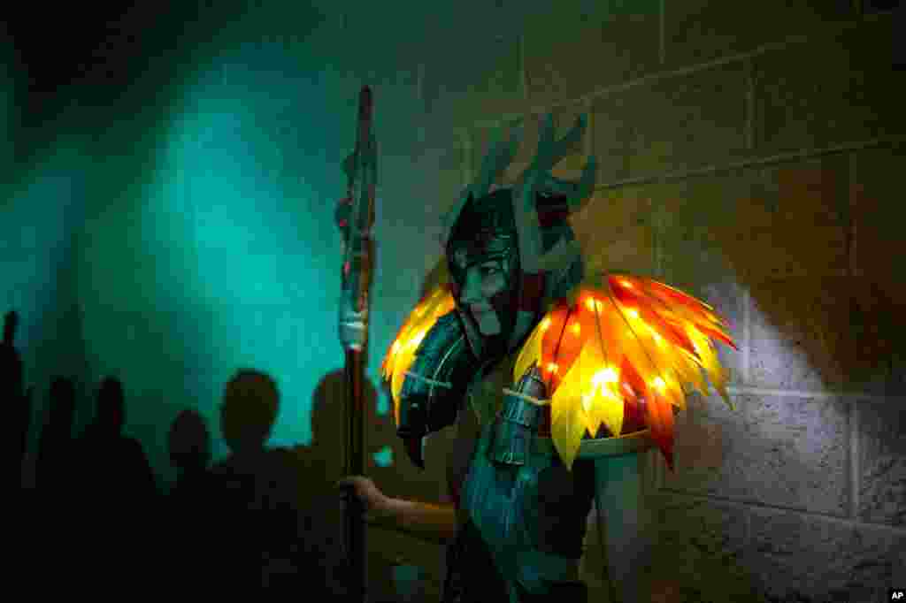 Katia Schiele, dressed as Leyara from the video game World of Warcraft, pauses for photos at BlizzCon in Anaheim, California. "World of Warcraft" maker Blizzard is hosting its ninth annual fan-centric convention that opened on Friday.