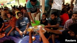 FILE - Ahmadi refugees from Pakistan eat at the Ahmadiyya Muslim Community Center in Pasyala, Sri Lanka, April 26, 2019. 