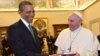 Pope Francis and President Barack Obama smile as they exchange gifts, at the Vatican, March 27, 2014.