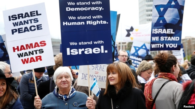 People hold placards during the "Rally for Equal Rights at the United Nations (protesting Anti-Israeli bias)" aside of the Human Rights Council at the United Nations in Geneva, Switzerland, March 18, 2019.