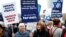 People hold placards during the "Rally for Equal Rights at the United Nations (protesting Anti-Israeli bias)" aside of the Human Rights Council at the United Nations in Geneva, Switzerland, March 18, 2019. 