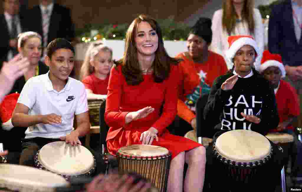 Britain&#39;s Catherine, Duchess of Cambridge, takes part in drumming &#39;music therapy&#39; as she attends the Anna Freud Centre Family School Christmas Party at Anna Freud Centre, in London.