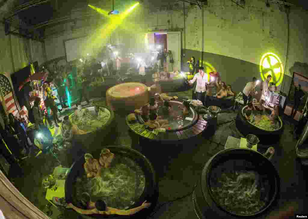 Movie fans enjoy a hot bubble bath while watching a movie at the Hot Tub Movie Club in Amsterdam, Netherlands, Mar. 6, 2014. 