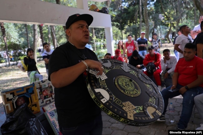 Jonathan Rulleri, the founder of Poleanas Canada Frogs, holds up a poleana board to be raffled off before the start of a tournament in Mexico City, Sunday, Nov. 17, 2024. (AP Photo/Ginnette Riquelme)