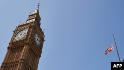 The British flag flies at half-staff above Portcullis House beside the landmark Elizabeth Tower, more commonly known as Big Ben, in central London in tribute to the victims of a jihadist massacre in Tunisia, July 3, 2015. 