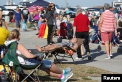 Visitors stake out spots near the fishing pier at Jetty Park to watch SpaceX's first Falcon Heavy rocket launch from the Kennedy Space Center, Florida, Feb. 6, 2018.