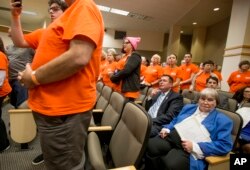 Gun lobbyist Marion Hammer, right, and Eric Friday, general counsel for Florida Carry, sit among protesters during the Senate Rules Committee meeting on gun safety at the Florida state Capitol after a rally in Tallahassee, Fla., Feb. 26, 2018.