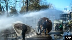 Grčka policija vodenim topovima pokušava da spreči migrante da probiju ogradu na granici Turske i Grčke u provinciji Edirne, 7. marta 2020.