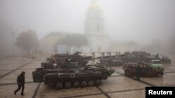 FILE - A man walks past destroyed Russian military vehicles outside St. Michael's Golden-Domed Monastery on a foggy morning, amid Russia's attack on Ukraine, in Kyiv, Ukraine October 21, 2023. 