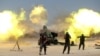 Shi'ite fighters with Iraqi security forces fire artillery during clashes with Islamic State militants near Falluja, Iraq, May 29, 2016.