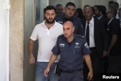 FILE - Gery Shalon (L), who is accused by U.S. authorities of engaging in a stock manipulation scheme involving U.S. penny stocks, arrives at a courtroom at the Jerusalem Magistrates Court July 22, 2015.