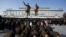 North Korean soldiers bow before the statues of late leaders Kim Il Sung, left, and Kim Jong Il, right, at Mansu Hill in Pyongyang, North Korea, December 17, 2012.