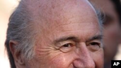 FIFA president Joseph S. Blatter smiles before the start of a friendly match between the Senegalese club team Dakar and the Palestinian refugee camp team from Amari, in the West Bank town of Aram, near Ramallah, Sunday, May 15, 2011. Blatter said Sunday h