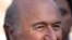 FIFA president Joseph S. Blatter smiles before the start of a friendly match between the Senegalese club team Dakar and the Palestinian refugee camp team from Amari, in the West Bank town of Aram, near Ramallah, Sunday, May 15, 2011. Blatter said Sunday h