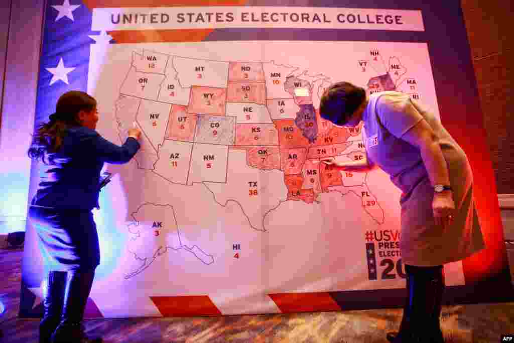 People color an electoral map during a U.S. presidential election watch party at the U.S. embassy in Ulaanbaatar, the capital of Mongolia.