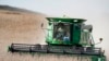 FILE - A combine harvests soybeans in rural Blair, Neb., Oct. 17, 2019. 