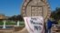 FILE - In this 2014 photo, aTexas Tech student drape a bed sheet with the message "No Means No" over the university's seal at the Lubbock, Texas campus.