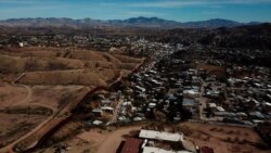 The U.S. border fence separates Nogales, Mexico, right, from sister city Nogales, Arizona, left, Jan. 3, 2020.