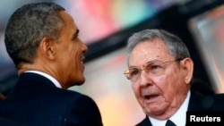 U.S. President Barack Obama greets Cuban President Raul Castro at a memorial service for late South African President Nelson Mandela, Johannesburg, Dec. 10, 2013.