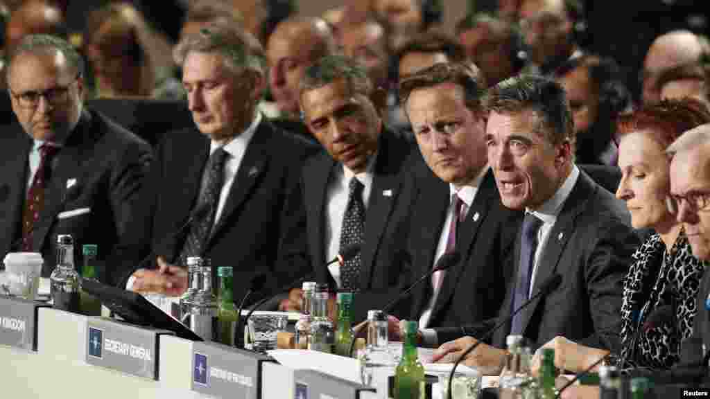 U.S. President Barack Obama, third from left, and British Prime Minister David Cameron, fourth from left, listen to NATO Secretary General Anders Fogh Rasmussen, third from right, as they participate in NATO Summit Session One, on Afghanistan and the Isla