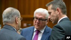 German Foreign Minister Frank-Walter Steinmeier, center, speaks with Cypriot Foreign Minister Ioannis Kasoulides, left, and Danish Foreign Minister Kristian Jensen, right, during a meeting of EU foreign ministers at the EU Council building in Brussels, Nov. 14, 2016.