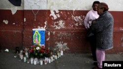Family members wait outside the morgue where the bodies of victims were taken after a fire at the Virgen de Asuncion home in San Jose Pinula near Guatemala City, March 9, 2017.