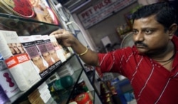 FILE - An Indian salesman arranges men's fairness products at a shop in New Delhi, Sept. 4, 2007.