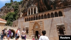 FILE - People visit the Monastery of Saint Anthony of Qozhaya in the heart of the Qadisha valley, in Zgharta district, Lebanon, June 23, 2019. 