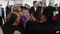 Thai hostage who were freed from Hamas, Bannawat Saethao, second from left, hugs his relatives of upon his arrival at Suvarnabhumi International Airport, in Samut Prakarn Province, Thailand, Feb. 9, 2025.