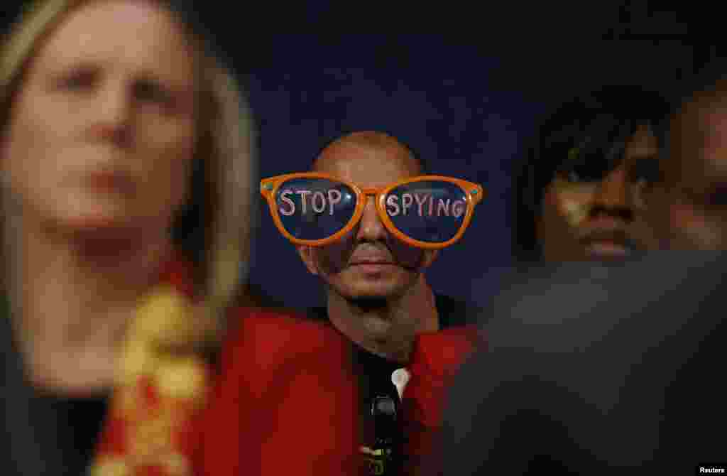 A protester against the practices of U.S. security agenices sits in the audience as Director of National Intelligence James Clapper, Deputy Attorney General James Cole and General Keith Alexander, director of the National Security Agency (not pictured) testify at a House Intelligence Committee hearing on Capitol Hill in Washington, D.C., Oct. 29, 2013.