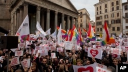 Activists demonstrate in favor of rights for gay couples prior to a debate to be opened in Italian parliament to change laws on recognition of rights for same-sex couples, in Rome, Jan. 23, 2016. 