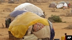 A child stands in front of her home at a refugee camp in Dadaab, Kenya, Thursday, Aug 4, 2011.