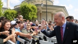 Turkey's President Recep Tayyip Erdogan speaks to his supporters after Friday prayers, in Ankara, Turkey, Aug. 23, 2019. Also on Friday, Erdogan discussed the situation in Syria with Russia's President Vladimir Putin.