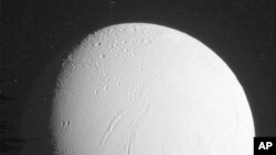 FILE - The Cassini spacecraft captured this of Saturn's moon Enceladus, in a flyby Oct. 28, 2015. The U.S.-European spacecraft skimmed within 30 miles of the south pole. (NASA/JPL-Caltech/Space Science Institute via AP)