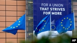 European Union flags flap in the wind outside EU headquarters in Brussels, Monday, Jan. 27, 2020. The U.K. is due to leave the EU on Friday, the first nation in the bloc to do so. It then enters an 11-month transition period in which Britain will…