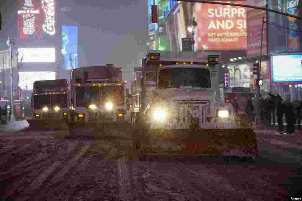 New York City plow trucks clear the streets of Times Square, Jan. 2, 2014. 