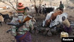 Turkana armed tribesmen stand around a borehole in order to protect their cattle from rival Pokot and Samburu tribesmen near Baragoy, Kenya, Feb. 14, 2017. 