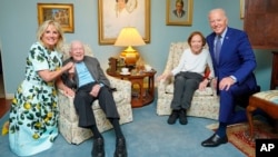 FILE - In this April 30, 2021, photo released by The White House, former President Jimmy Carter and former first lady Rosalynn Carter pose for a photo with President Joe Biden and first lady Jill Biden at the home of the Carters in Plains, Georgia. 