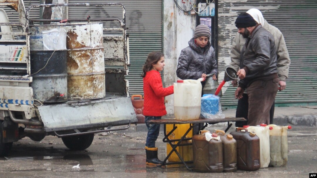 Syrians buy petrol on a street in the northwestern city of Idlib on December 30, 2016. A fragile calm is holding across Syria after a truce brokered by Russia and Turkey came into effect.