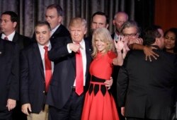 FILE - President-elect Donald Trump and campaign manager Kellyanne Conway celebrate during an election night rally.