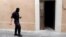 A member of the French police special forces (GIPN) walks in front of the house where two presumed members of ETA were arrested in Montpellier, southern France, May 7, 2013.
