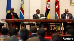 Three East African presidents, (from R) Uhuru Kenyatta of Kenya, Yoweri Museveni of Uganda and Paul Kagame of Rwanda, hold a joint news conference soon after their meeting in Entebbe, 36km (22 miles) southwest of the capital Kampala, June 25, 2013.