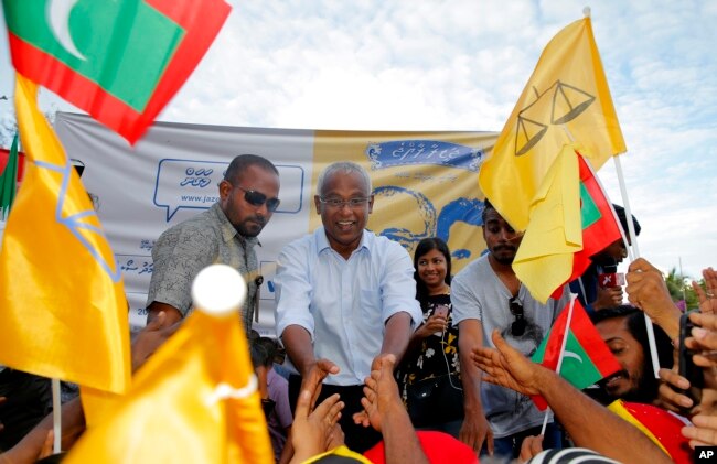 FILE - Ibrahim Mohamed Solih (C), the president-elect of the Maldives, interacts with his supporters during a gathering in Male, Maldives, Sept. 24, 2018.