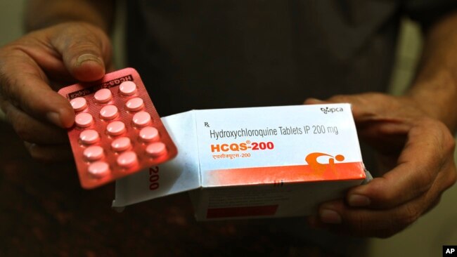 In this Thursday, April 9, 2020 file photo, a chemist displays hydroxychloroquine tablets in New Delhi, India. Chloroquine and the related drug hydroxychloroquine have been pushed by President Donald Trump after some early tests suggested the drugs might