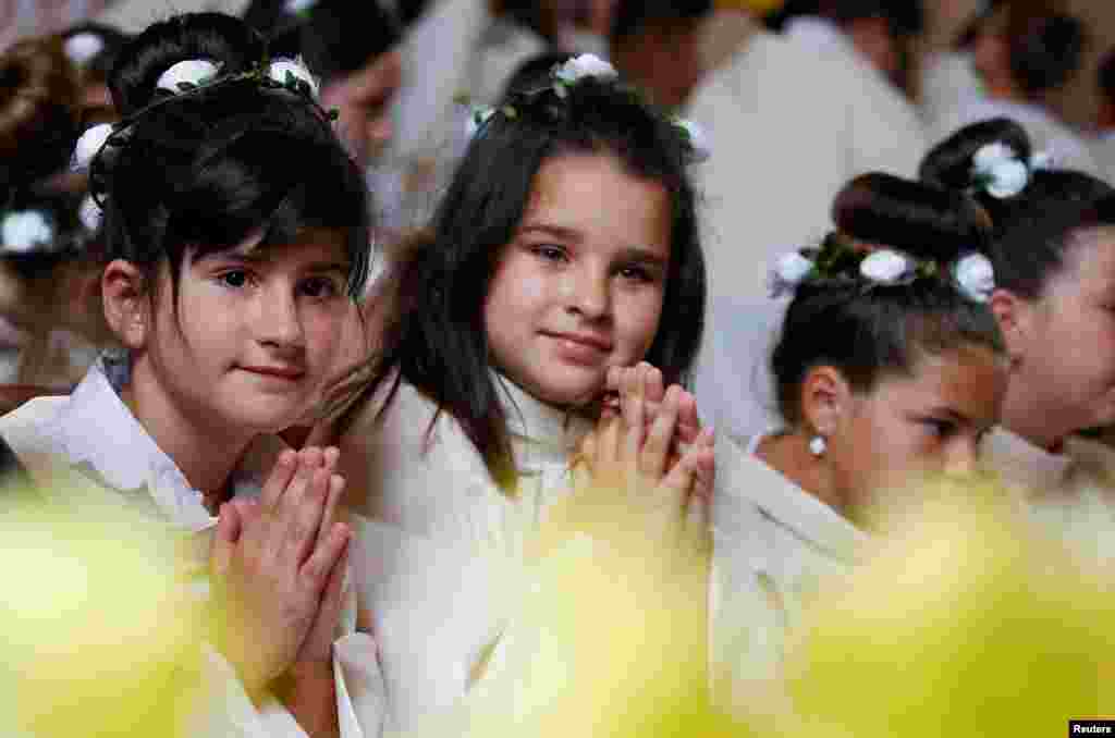 Catholics wait for Pope Francis to lead the Holy Mass with First Communions at Most Holy Heart of Jesus church in Rakovski, Bulgaria.