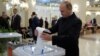 FILE - Russian President Vladimir Putin casts a ballot at a polling station during a parliamentary election in Moscow, Sept. 18, 2016.